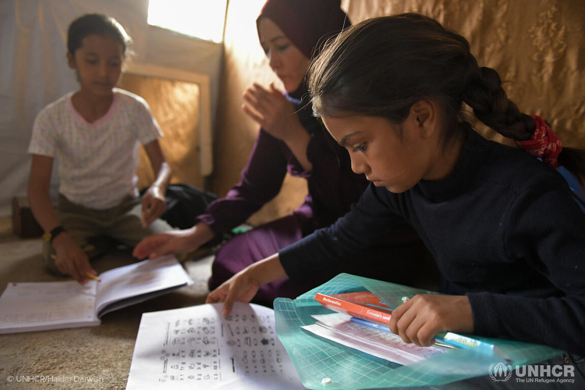 Majidas daughters Sara and Aya do their homework in the familys shelter