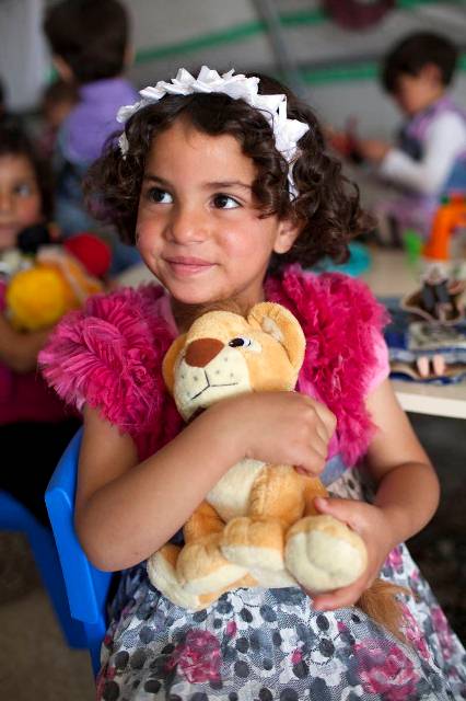 Four-year-old Tesmim, who attends primary school in Nizip, clings to her new best friend – a fluffy lion.