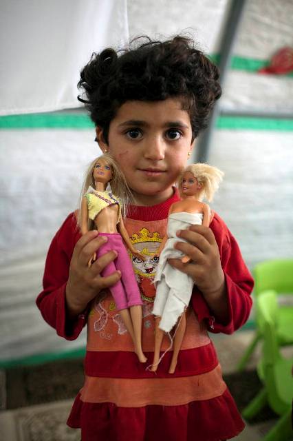 This young girl was happy to get two dolls because she had to leave all her toys behind when she fled from Syria.