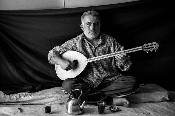 Omar, 37, holds a buzuq, or long-necked lute – the most important thing that he was able to bring with him to Domiz refugee camp in the Kurdistan Region of Iraq.