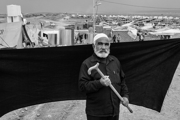 Ahmed, 70, holds his cane in Domiz refugee camp in the Kurdistan Region of Iraq. Without it, he says, he could not have made the two-hour crossing on foot to the Iraqi border.