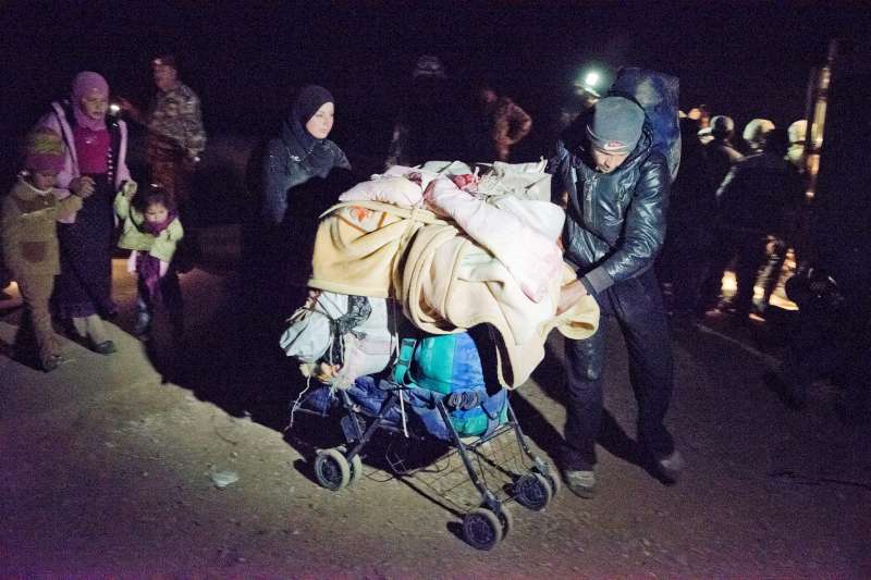 A group of Syrian refugees cross at night into Jordan. They make their way by foot from the Syrian governorate of Daá'ra carrying what they can. It's a risky journey.