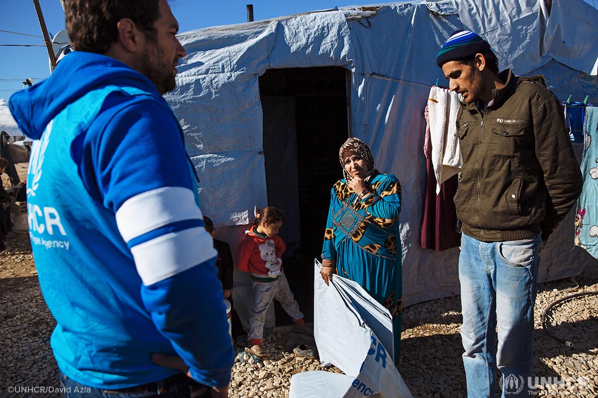 Syrian refugees Hamra and Malek receive winter assistance from UNHCR for their shelter in Lebanon.