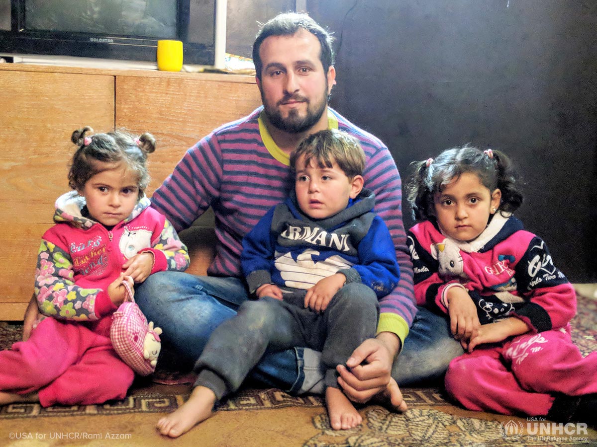 A Syrian refugee family gathers in their home at an informal settlement in Lebanon.