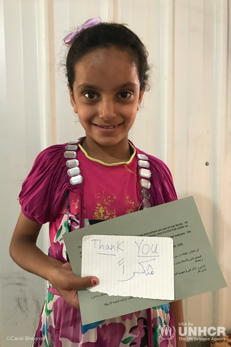 Girl with thank you note from Carol Shearon's mission trip to Jordan