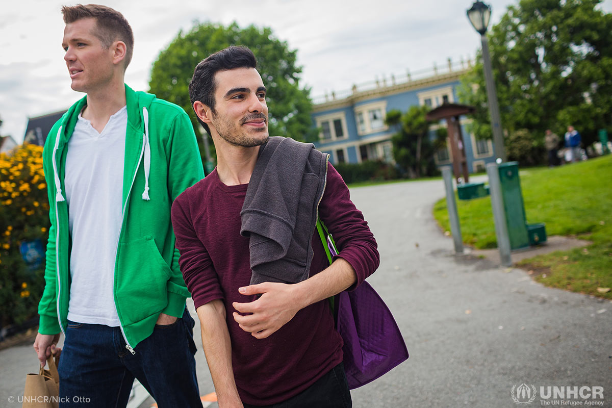Subhi Nahas, a Syrian LGBTI refugee and his American partner carry groceries as they head to a friend's dinner party.
