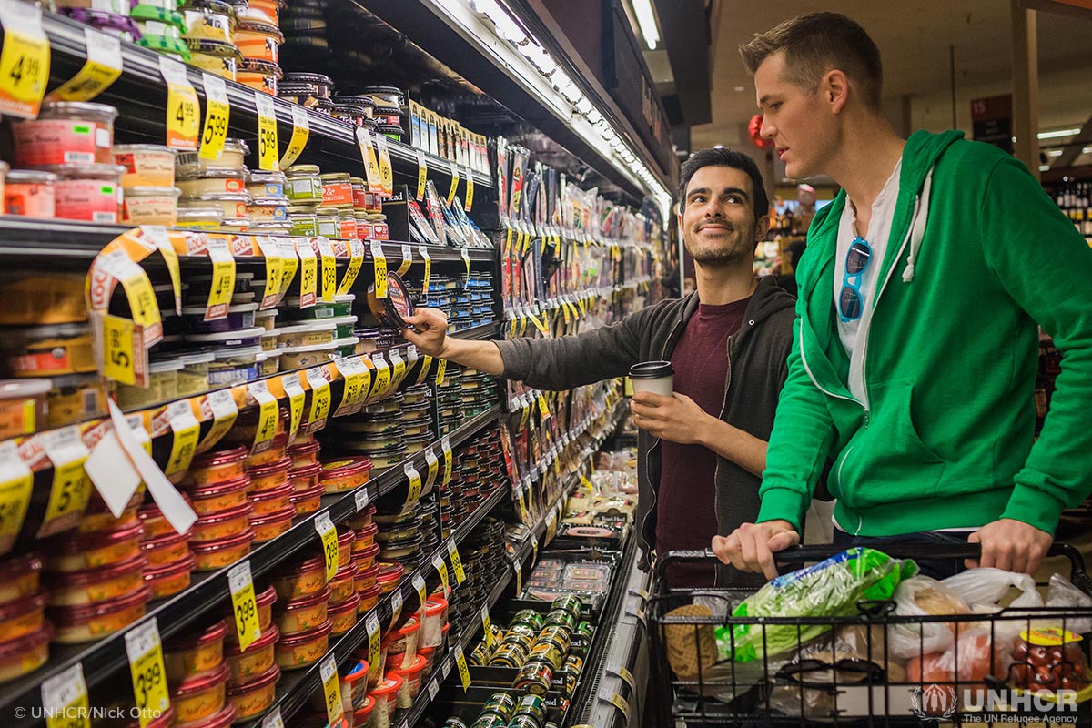 Subhi Nahas, a Syrian LGBTI refugee shops for groceries with his American partner in the Castro District of San Francisco.
