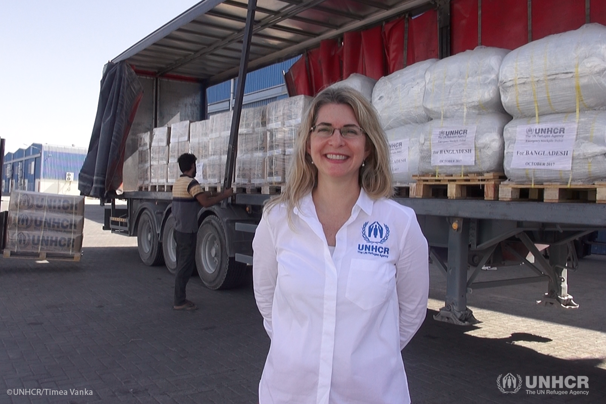 UNHCR's Head of Supply Management and Logistics Anna Spindler in front of a truck being loaded with core relief items from UNHCR's warehouse in Dubai, in preparation for an airlift to Bangladesh.