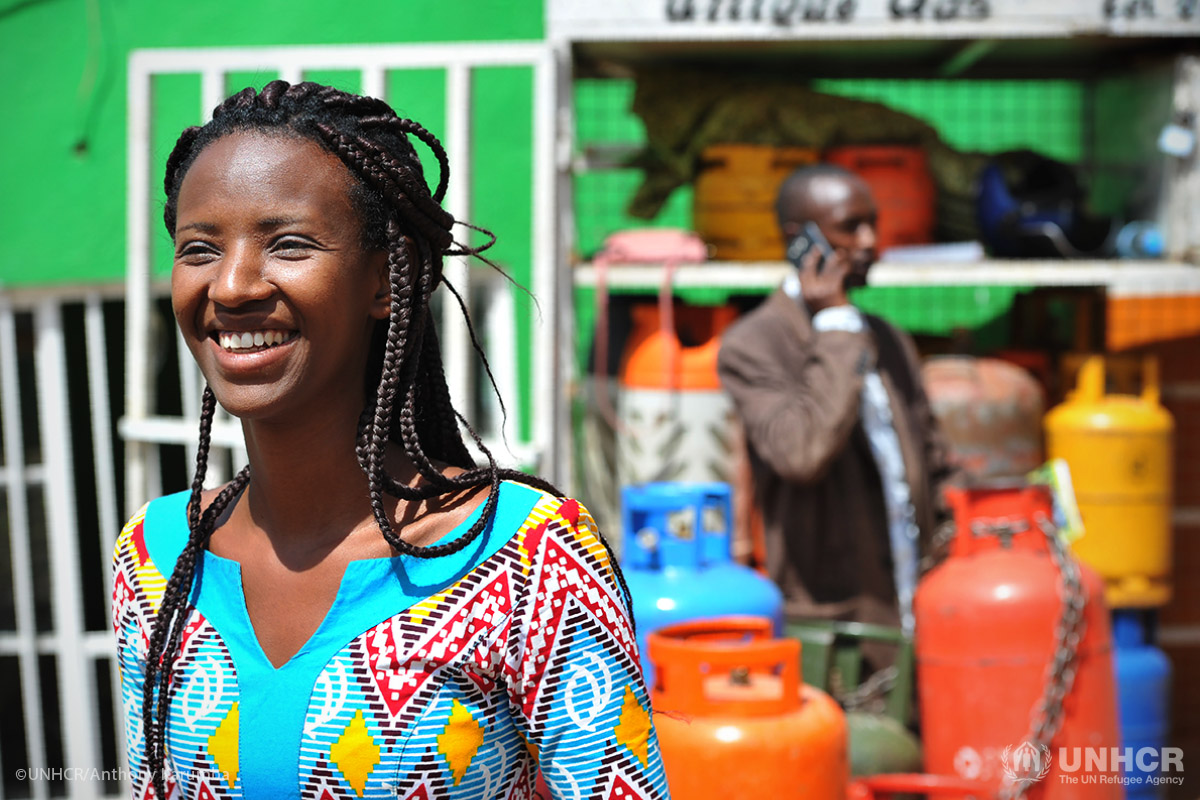 Annick Iriwacu from Burundi stands outside her cooking gas retail outlet in Rwanda's capital, Kigali, which she runs with her brother Darcy. Annick, a mother of three, fled Burundi in 2015.