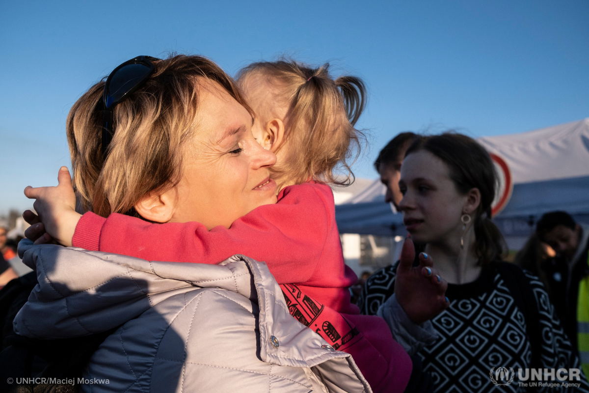 Displaced woman and child from Ukraine hug