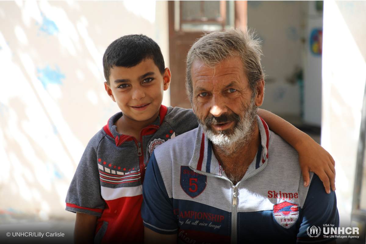 Syrian refugee Abdul Hameed and his grandson Odai sit outside their house in Amman, Jordan.