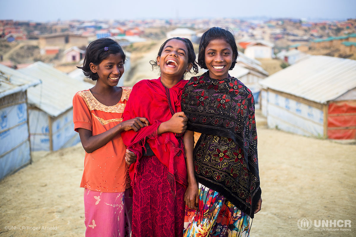 Anarkoli, 11, in black shawl, and Nur Qayeda, 9, in orange shirt and Subeda Bibi, 10, in red scarf, at her shelter in Kutupalong Refugee Camp.