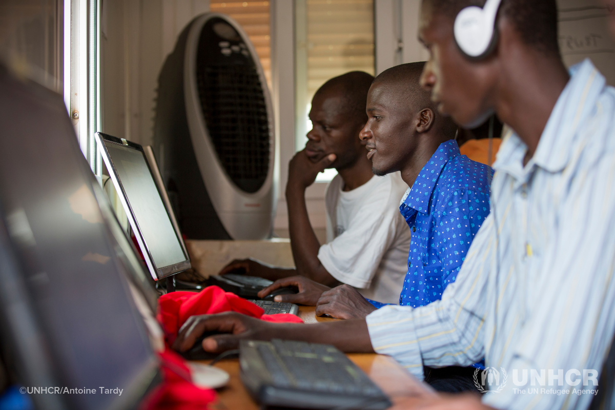 Refugees in Kakuma sitting in row of desks in front of computers
