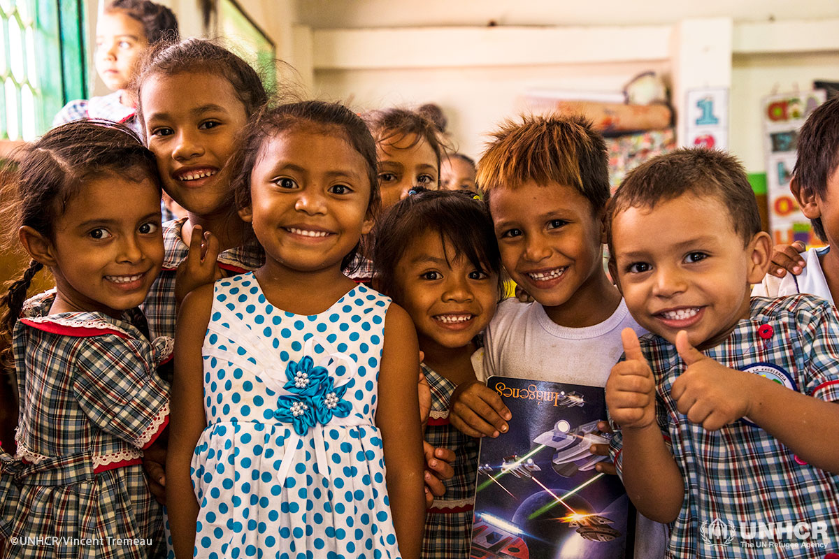 Students smile in their classroom in a school in Paraguachon.