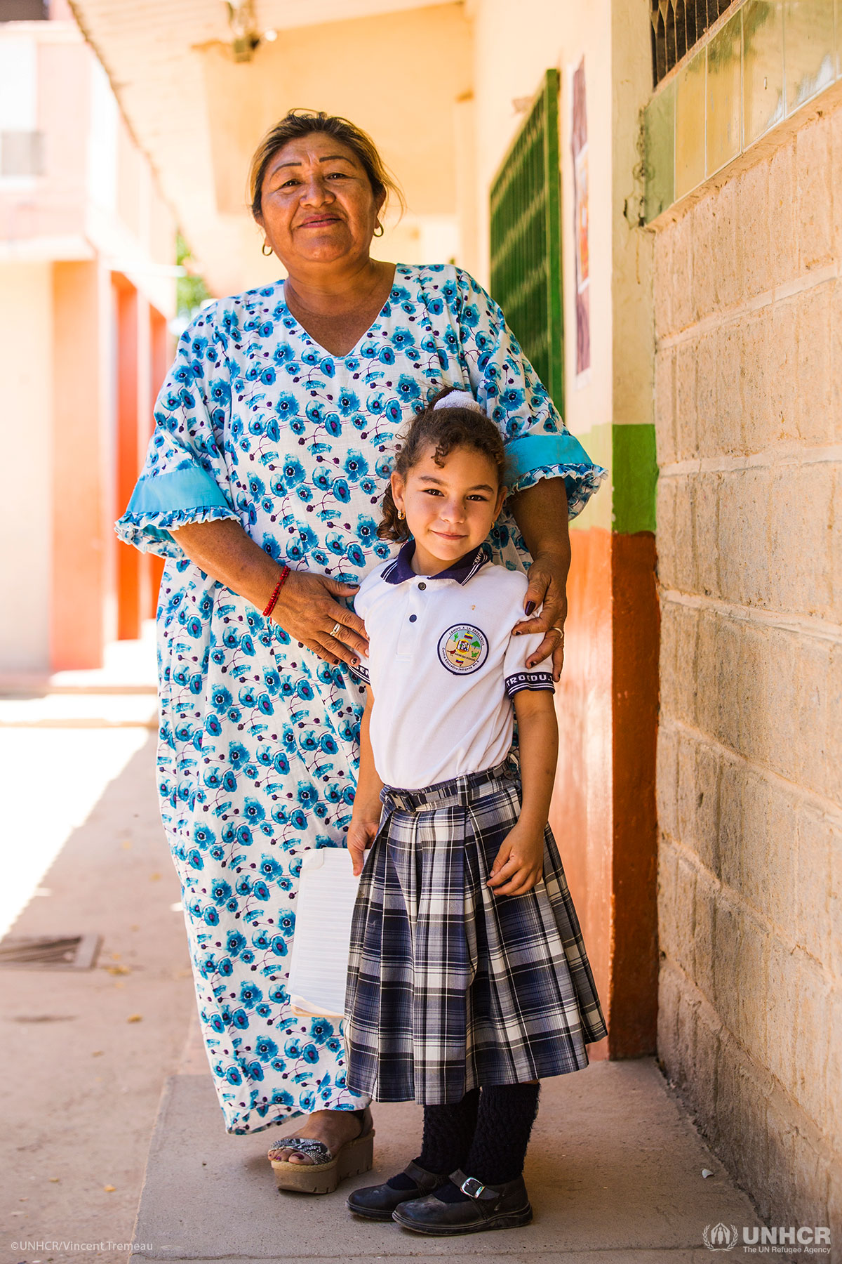 Portrait of Ms Letitia and one of her students, in the school yard, in a school in Paraguachon.