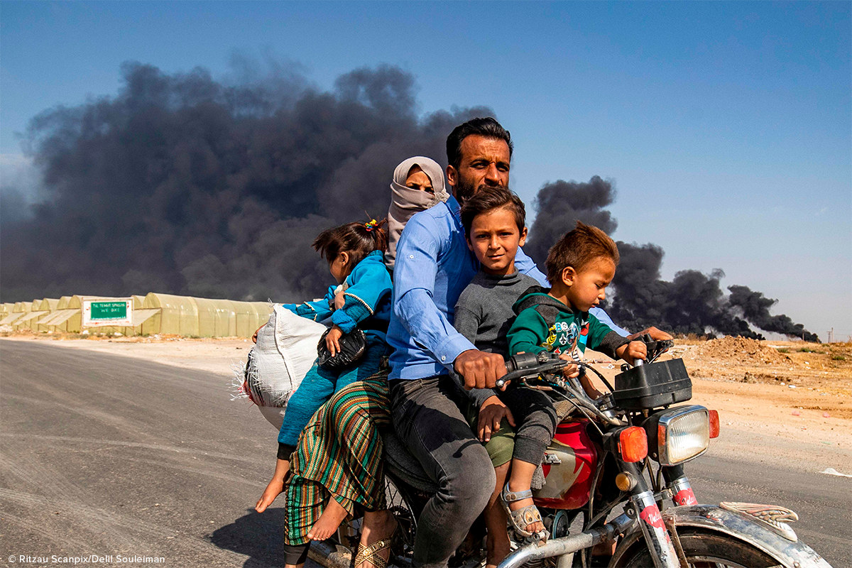 syrian family of five fleeing on motorcycle