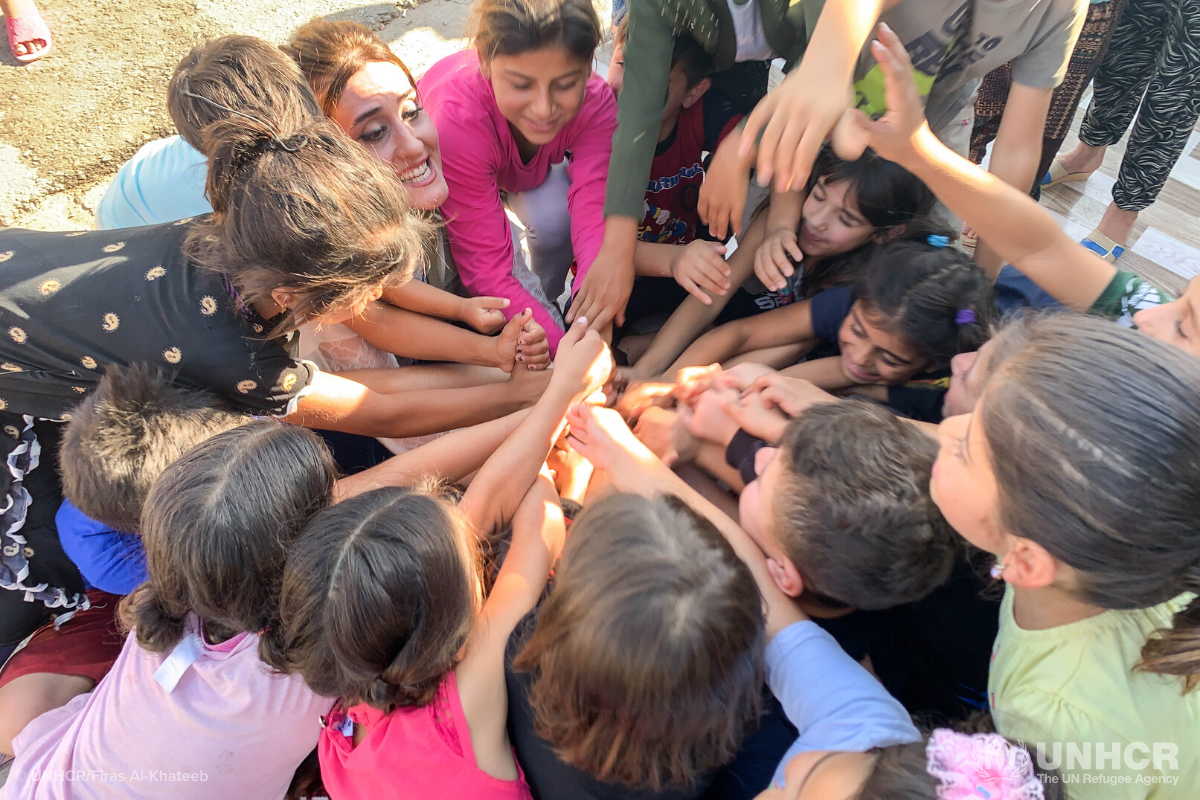 group of children with hands together in the center