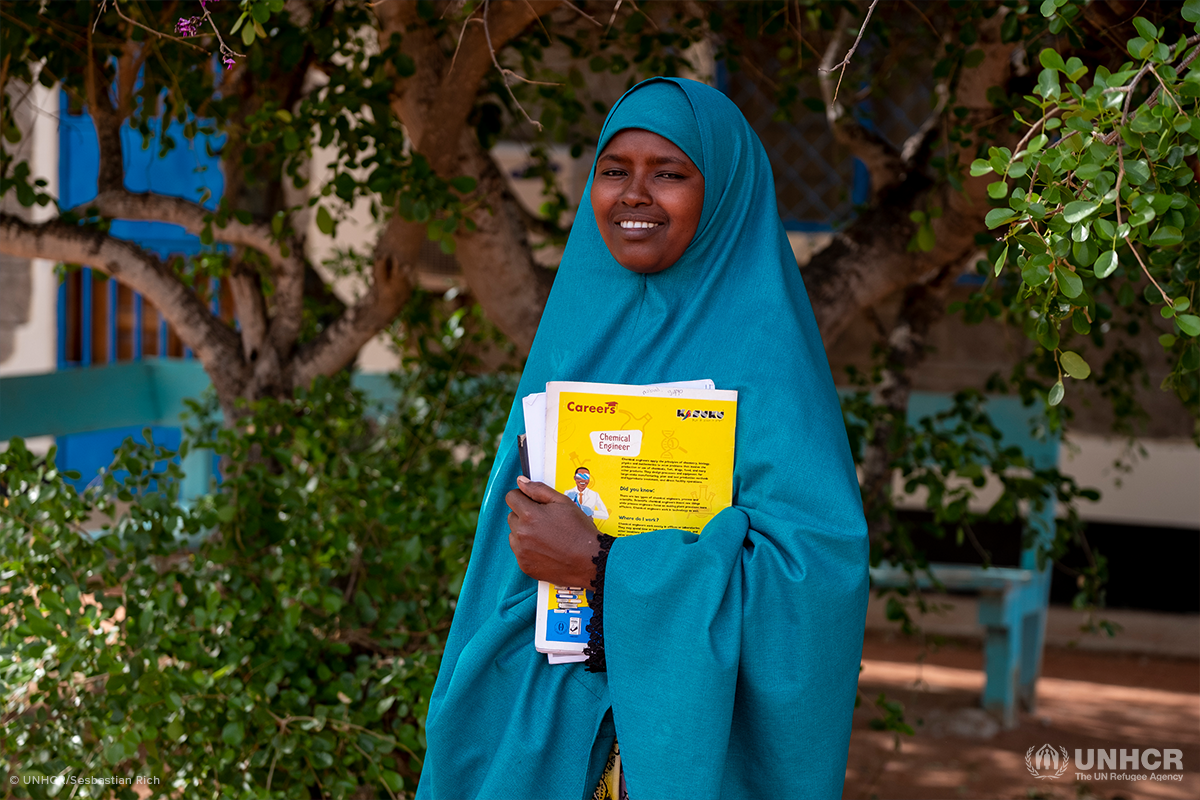 smiling somali refugee woman holding books