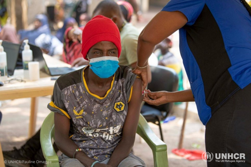 Hassan Abdul, a 22-year-old Somali refugee, receives a COVID-19 vaccine in Kakuma refugee camp, Kenya.