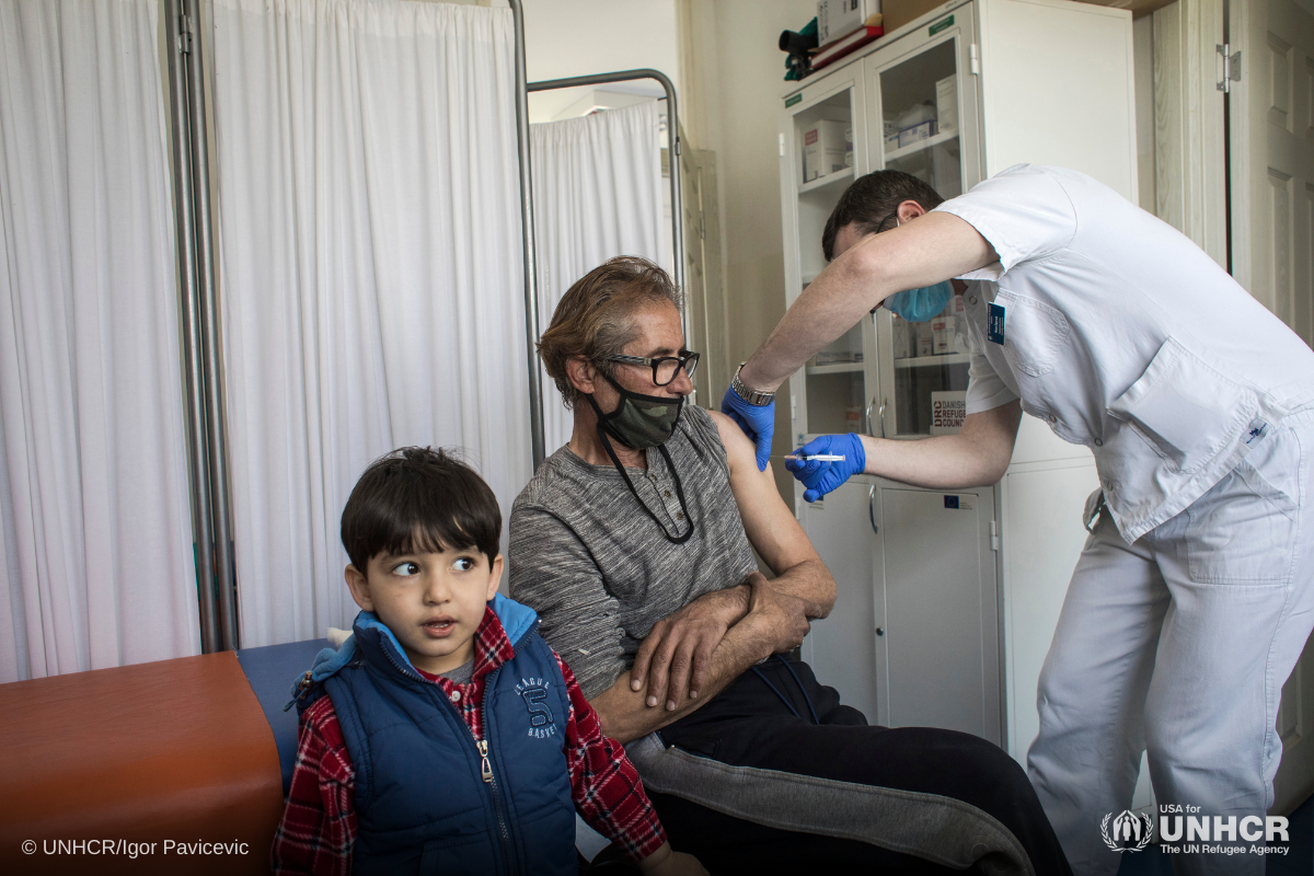 A resident of an asylum centre outside Belgrade receives a jab of coronavirus vaccine.