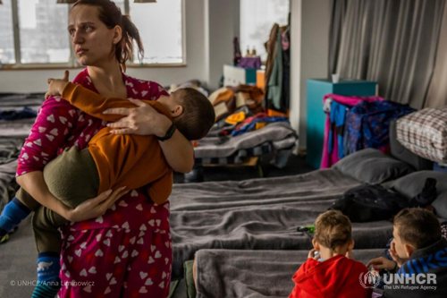 Kateryna holds her son Arsen, 2, at the shelter where she and her family live with 400 other refugees from Ukraine. Although her husband has found a job, they have not been able to find an apartment to rent.