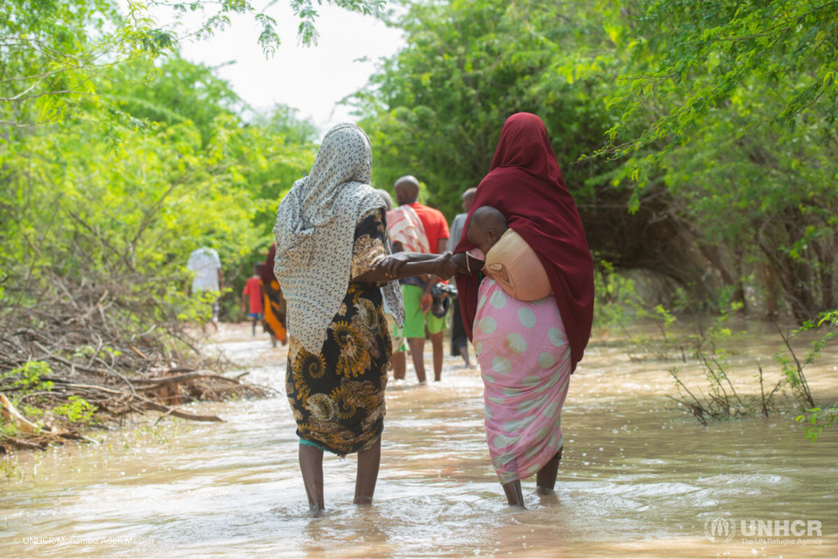 women walking through flooding, climate crisis