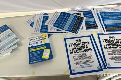 Pamphlets, booklets, and resources on a table at a UNHCR-led Blue Dot Center in Warsaw, Poland.