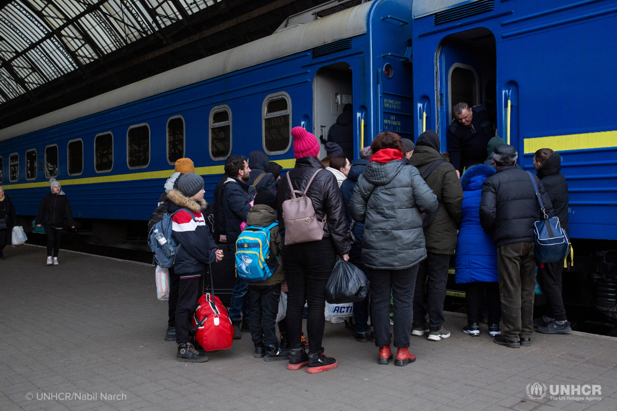 Ukrainian family at train station fleeing Ukraine at the start of the conflict