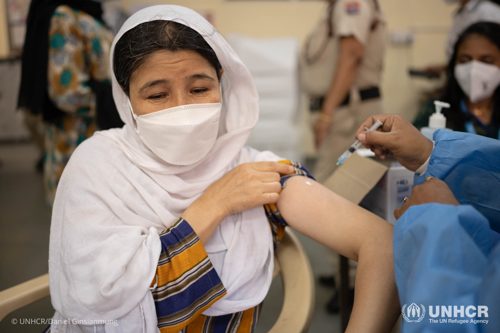 In the COVID-19 vaccination center, Zhara Shafaie receives her first COVID-19 vaccine shot.