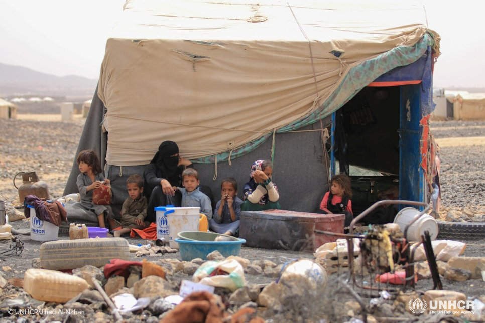 An internally displaced Yemeni family sit outside their shelter at Al Suwaidan camp in Marib city Yemen