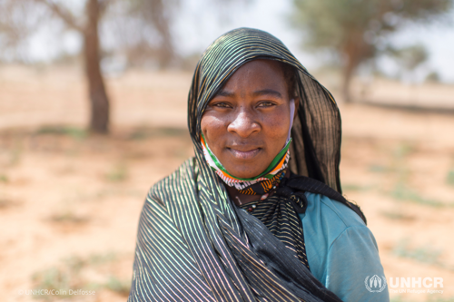 Rabi Saley stands in front of the camera with a shawl over head. She fled Mali after attacks on her hometown of Menaka.