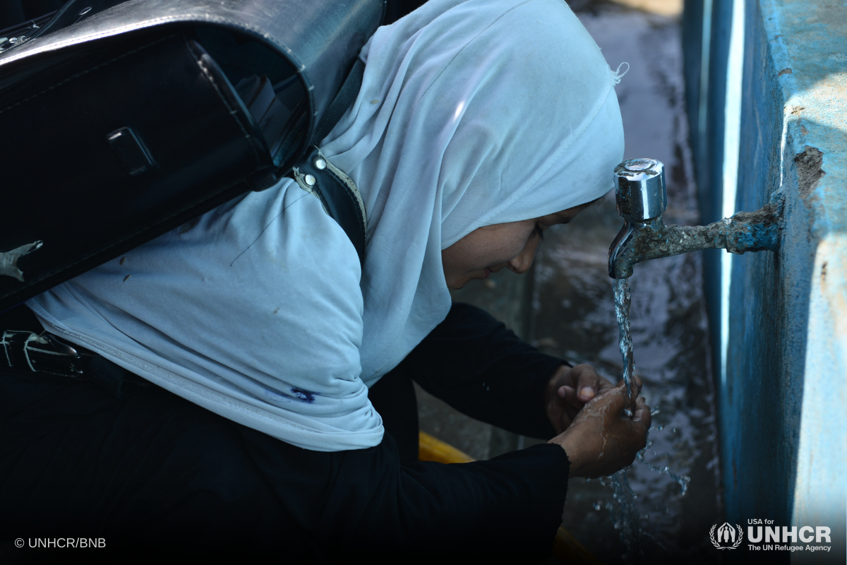 Talwasa washes her hands as she prepares to leave Daman Middle School in Afghanistan