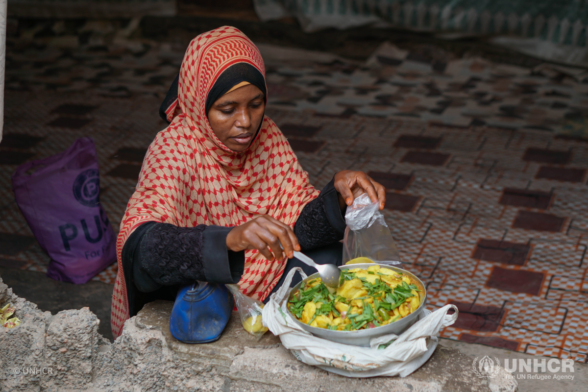 Habibah Hassan Othman Anood, a Somali refugee living in Yemen, sells ice cream and some potatoes.