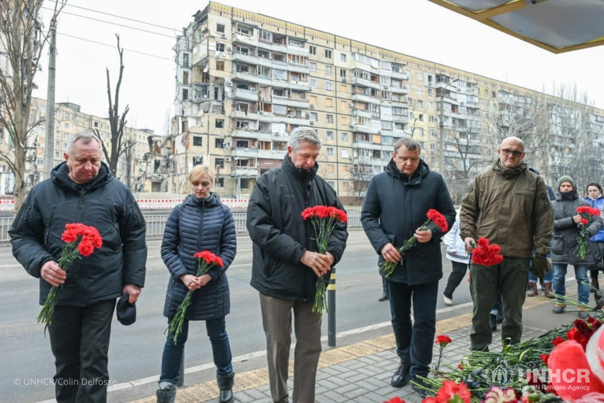 High Commissioner Filippo Grandi (center), alongside representatives of local authorities, lays flowers at a residential building that was destroyed during a missile strike on January 14 2023, in Dnipro city, Ukraine.
