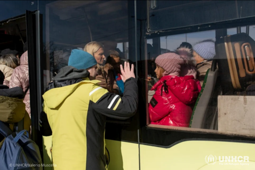 A father says farewell to his family at Lviv bus station in western Ukraine as they leave for safety.
