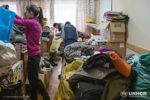 Oleksandra finds warm clothes for her children from among donations sent to the Mukachevo State University.