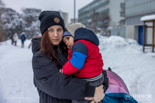 Kateryna with her 2-year-old son. She and her family fled Ukraine to Poland in March 2022. They will celebrate Orthodox Christmas at a shelter in Krakow where they share a room with around 30 people. 