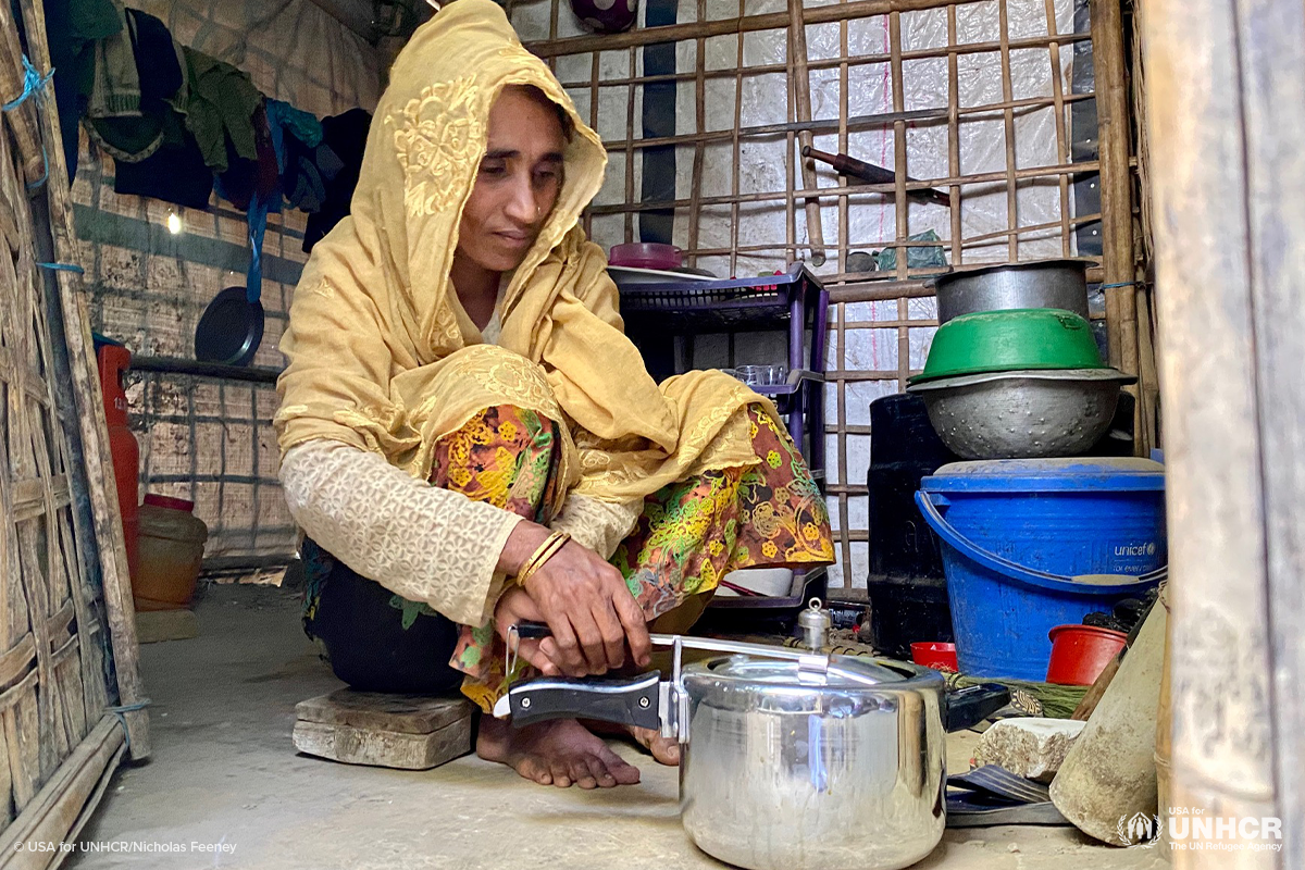 dhola uses a pressure cooker to make food for her family
