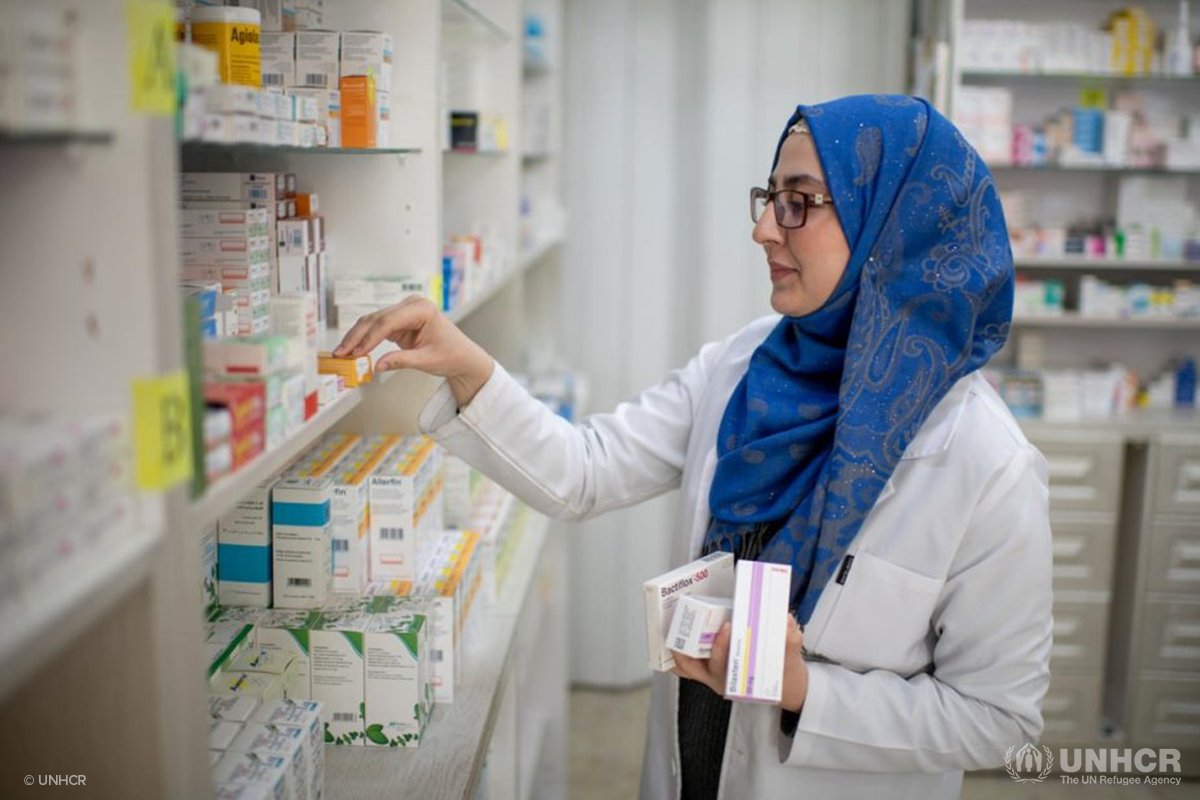 Syrian refugee and pharmacist in Jordan puts away medicine