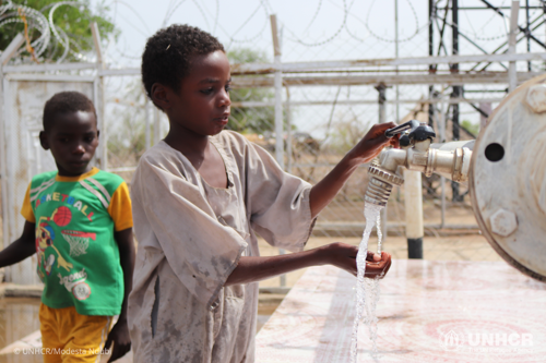 Two young Sudanese returnees gathering water in Mutur village, Um Dukhun Locality.