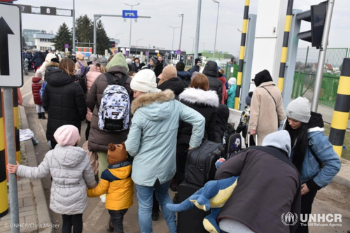 Refugees from Ukraine enter Poland at the Medyka border crossing.
