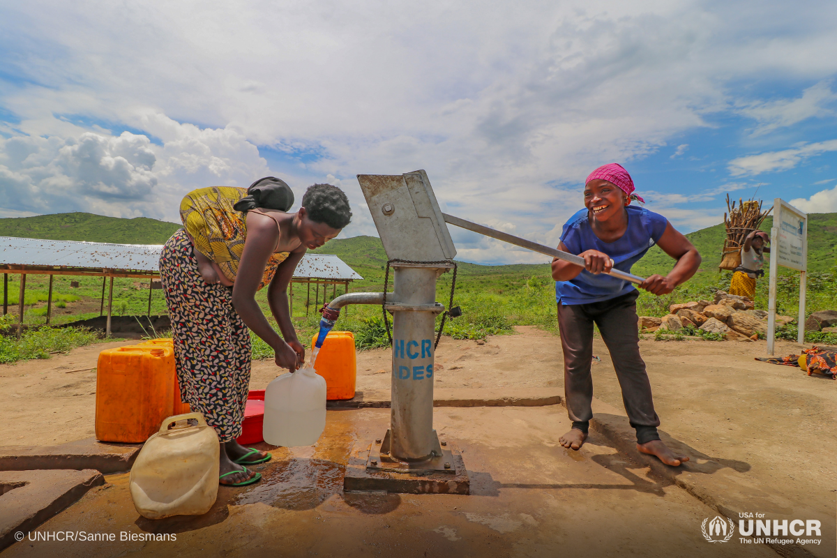 Aisha pumps water from a borehole in Mulongwe settlement in the Democratic Republic of the Congo.
