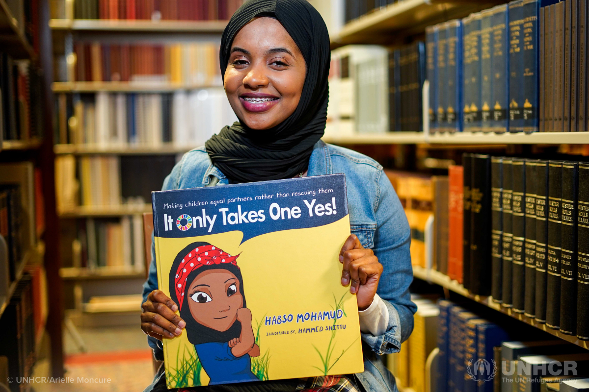 Somali refugee Habso Mohamud holds her childrens book It Only Takes One Yes