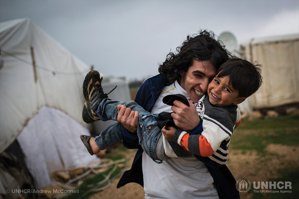 syrian refugee older brother plays with his younger brother