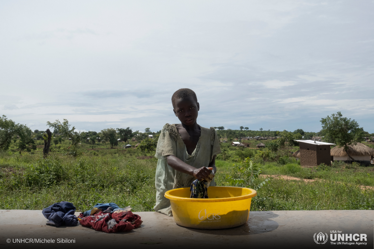 A young South Sudanese refugee does her laundry
