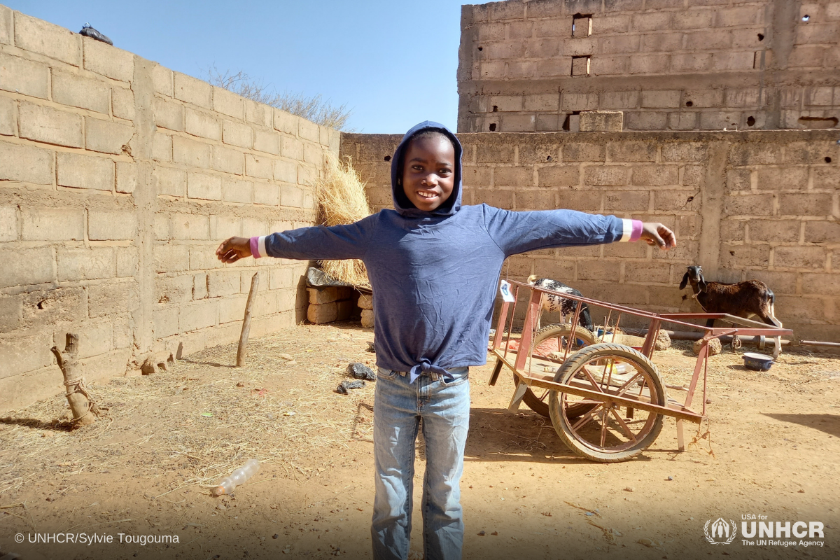 Refugee boy in Burkina Faso receiving his new sweater from Gap in-kind donation