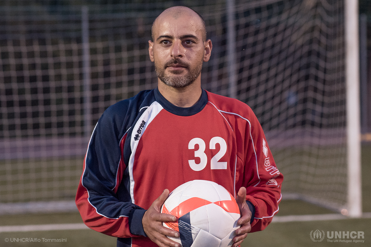 syrian refugee janghiz holds a soccer ball