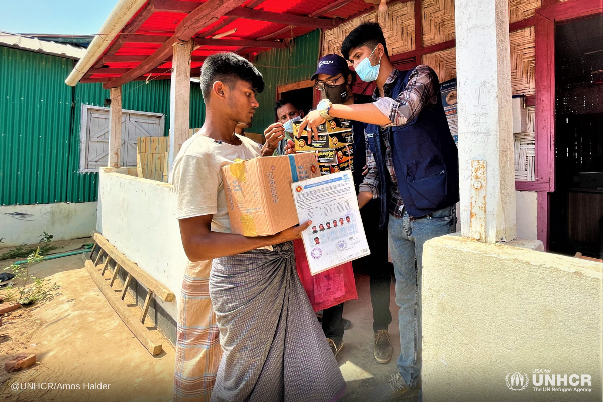 Refugee volunteers deliver aid to families affected by the fire in the Kutupalong-Balukhali camps, Bangladesh.