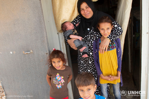 A Syrian mother and her four children stand outside their shelter in the Azraq refugee camp in Jordan.
