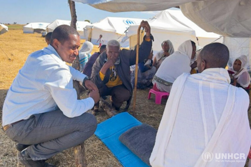 UNHCR Representative in Ethiopia, Mamadou Dian Balde (left), speaks to Eritrean refugees in the Alemwach settlement, in Ethiopia’s Amhara Region. 